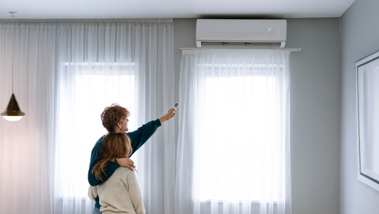 Person uses a mini split with remote